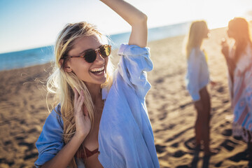 Three beautiful girls having fun on the beach