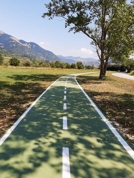 Green cycle lane for bikes in a mountain town in Italy