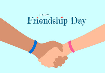 Happy Friendship Day concept. The hands of two friends as they hold each other. Blue and pink wristband that symbolize eternal friendship. Inscription with red heart decoration.