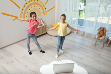 Cute little girls taking online dance class at home