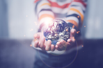 boy's hand holding a globe, The globe in children's hands. Concept for environment conservation.