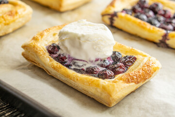 Delicious puff pastries with blueberries and ice cream. Concept for eating