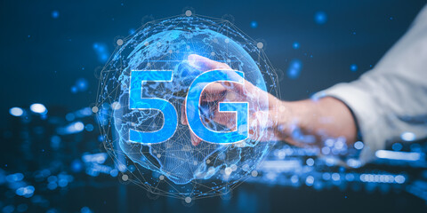 Businessman Pressing on the world of 5G, concept of future technology 5G network wireless systems and internet of things.