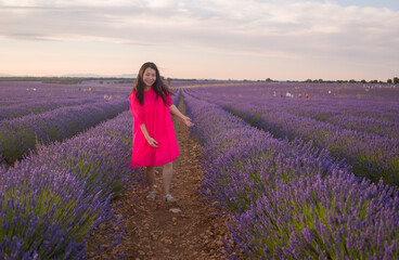 young happy and beautiful Asian Japanese woman in Summer dress enjoying nature free and playful outdoors at purple lavender flowers field in romantic beauty and freedom concept