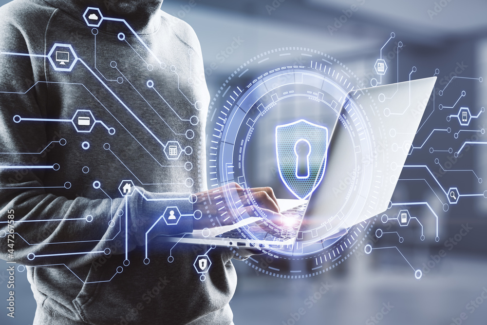 Poster hacker using laptop with creative glowing lock icon on blurry office interior background. web safety