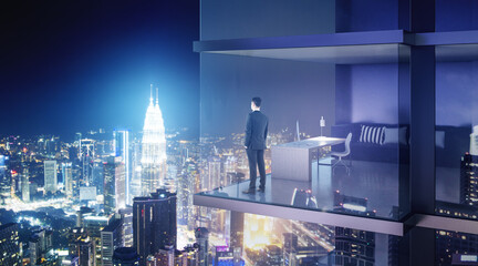 Leadership concept with businessman in skyscraper office with mesh walls looking on night megapolis city building lights.