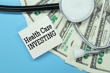 stethoscope, a colored board with the word healthcare investment