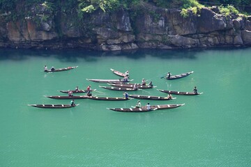 Fishermen at Dawki River Meghalaya, India. River has crystal clear water in a lush environment and...