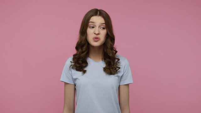 Unpleasant odor. Teenager lady with dark wavy hair pleasure and pinching nose, gesturing go away with your stinking breath, disgusting smell. Indoor studio shot isolated over pink background.