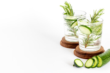 Fresh cold drink with cucumber lime and herbs in glasses