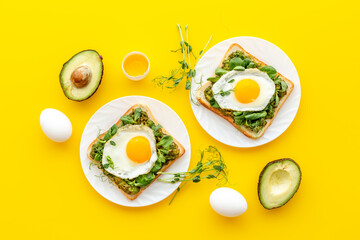 Breakfast with toasts of fried eggs and avocado saurce. Top view