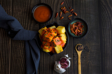 spicy Spanish patatas bravas with onion and garlic and pepper sauce - obrazy, fototapety, plakaty