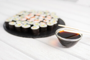 sushi on a plate with chopsticks