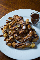 dish with Churros and chocolate, typical Spanish sweets. top view detail