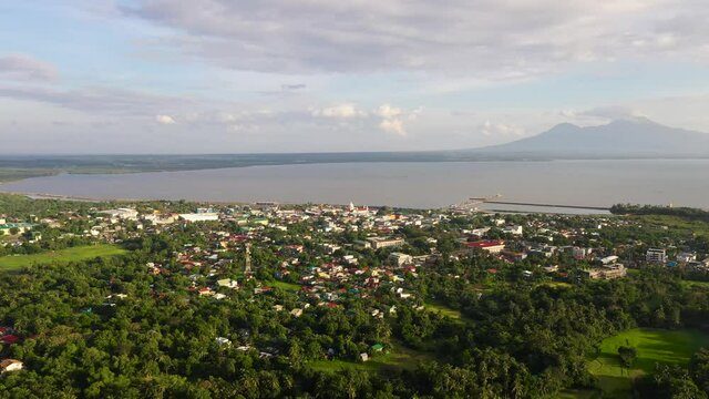 Sorsogon City, Luzon, Philippines. Town by the sea, top view. Landscape in Asia. Summer and travel vacation concept. View of a small town and a volcano in the distance.