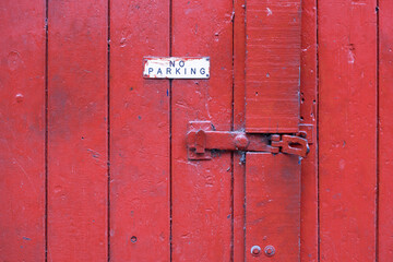 Red Garage Door with No Parking Sign