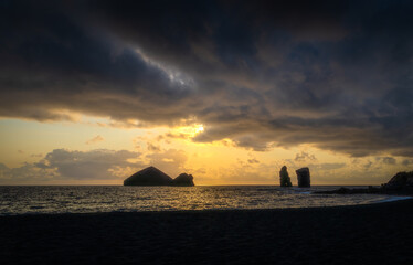 Naklejka na ściany i meble Sunset over the sea at the coasts of Mosteiros, Azores on a beautiful summer evening