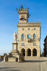 Fototapeta na wymiar The Statue of Liberty with Palazzo Publico in the background in San Marino