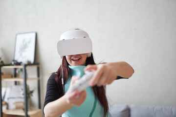 Woman with virtual reality headset is playing game.