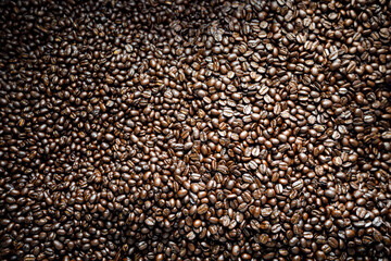 Close up of roasted coffee beans background abstract .
