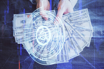 Multi exposure of technology drawing hologram and us dollars bills and man hands. Data concept