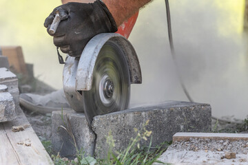 A person friction sawing a brick