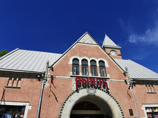 The market building (the inscription MARKET), built on the Market Square in 1905-1906, on a sunny summer day in Vyborg.
