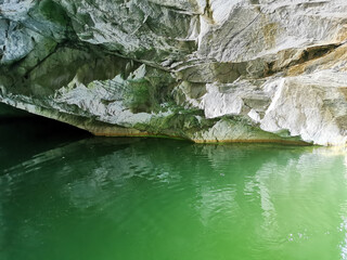The wall of the grotto, reflected in the emerald water of the Marble Canyon in the Ruskeala Mountain Park.