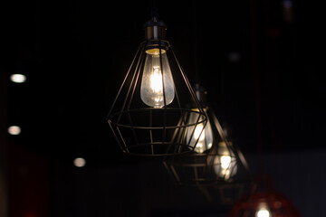 Stylish lamps hang in the dark.
