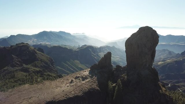DLOG Flat Aerial drone Flight at Monolith rock Roque Nublo, a volcanic rock in caldera of Tejeda, Gran Canaria, Canary islands, Spain.