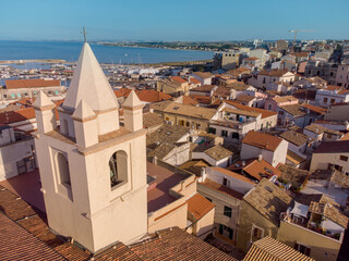 Aerial view of the ancient town of Termoli and the marina and dock on the background dominated by the bell tower of the Cathedral , Termoli , Italy