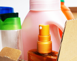 Photo of cleaning products standing on stacked cardboard boxes background.