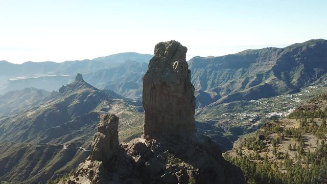 DLOG Flat Aerial drone Flight at Monolith rock Roque Nublo, a volcanic rock in caldera of Tejeda, Gran Canaria, Canary islands, Spain.