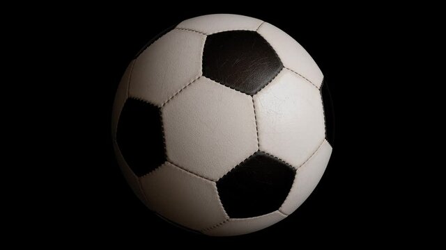 Rotating soccer ball isolated on black background. Sports football. Alpha channel 3d illustration