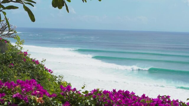 Video footage of beautiful view from the cliff to the blue ocean with lines of big waves for surfing in Bingin and Impossibles surf spot in Bali