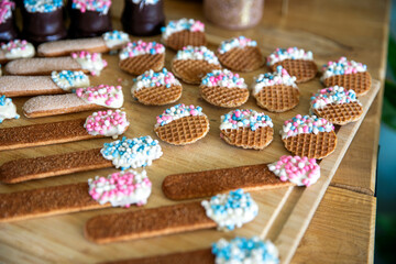 Colorful candies and cookies with baby and newborn symbol pink and blue for Gender reveal. Boy or girl, party and food concept