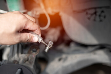 Technician remove Brake hose from brake caliper of the car in system check