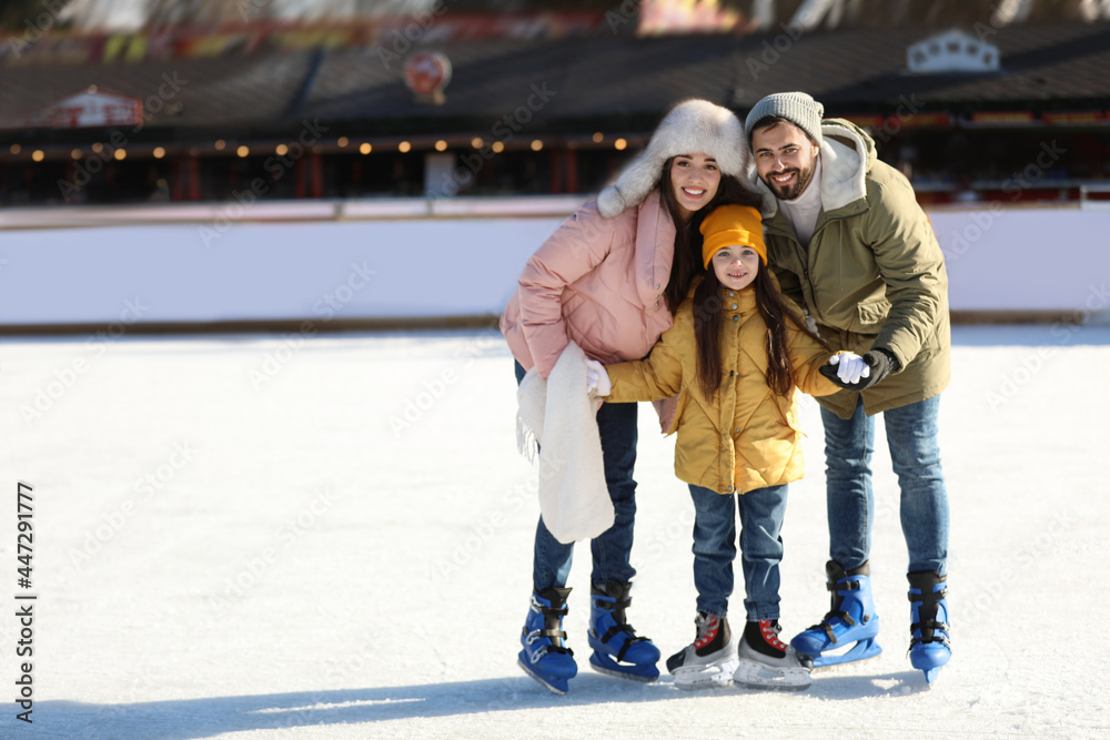 Wall mural happy family spending time together at outdoor ice skating rink, space for text