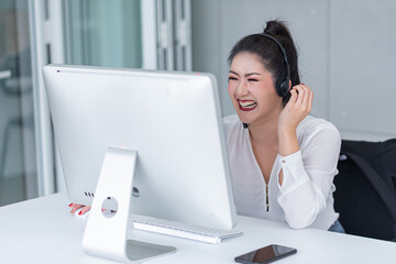 young asian woman working receiving call wear headphone consulting or solving problems for customers,Employees wearing headphones doing telemarketing