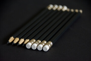 simple pencils with eraser on black background