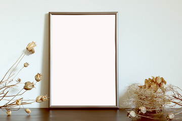 vertical photo frame on the table with dry flowers