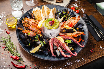 Seafood platter for 2-4 persons. Lobster, octopus, blue mussels, Argentina king prawns, tuna tartare. Delicious healthy traditional food closeup served for lunch in modern gourmet cuisine restaurant