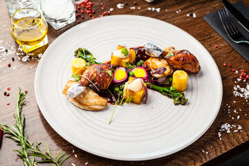 Chicken fillet, Jerusalem artichoke puree, dewberry sauce, potato, quail egg. Delicious healthy traditional food closeup served for lunch in modern gourmet cuisine restaurant