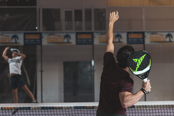 a boy paddle player ready to hit a ball.