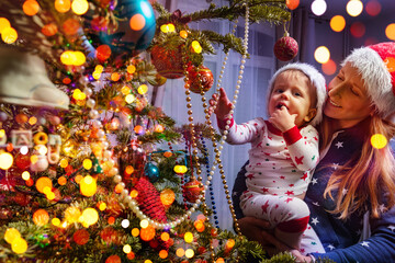 Mother with toddler son boy near Christmas tree