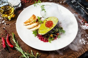 Tuna tartare. Trout roe, avocado cream, marinated onions. Delicious healthy Italian traditional food closeup served for lunch in modern gourmet cuisine restaurant