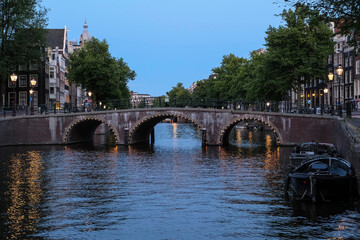 Fototapeta premium Sunset in the City of Amsterdam with colorfull reflections on the water, Amsterdam, Netherlands, Europe