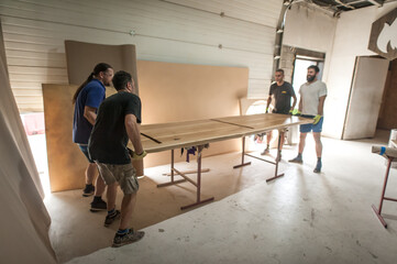 Team of carpenters making furniture in a workshop. Woodworking and crafts tools