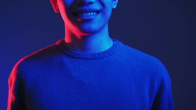 Neon light people. Positive emotion. Joyful expression. Red blue color glow unrecognizable happy satisfied pleased smiling guy isolated on dark background.