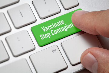 Coronavirus Vaccination Concept;Male hand pressing vaccinate stop contagion button.Computer user presses green key.